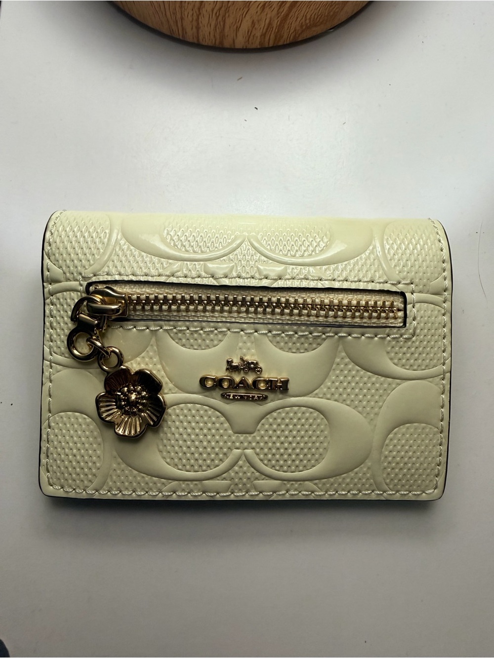 Coach Cream Quilted Leather Compact Wallet with Gold Floral Charm